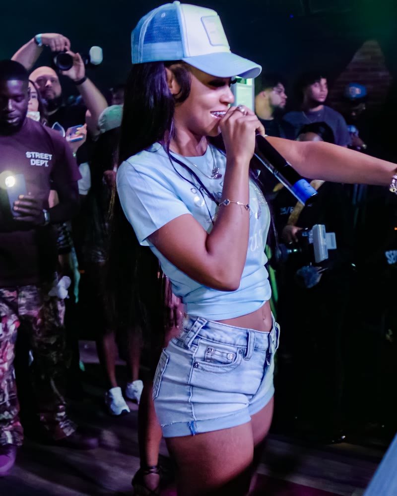Bigg Britt performing live, holding a microphone